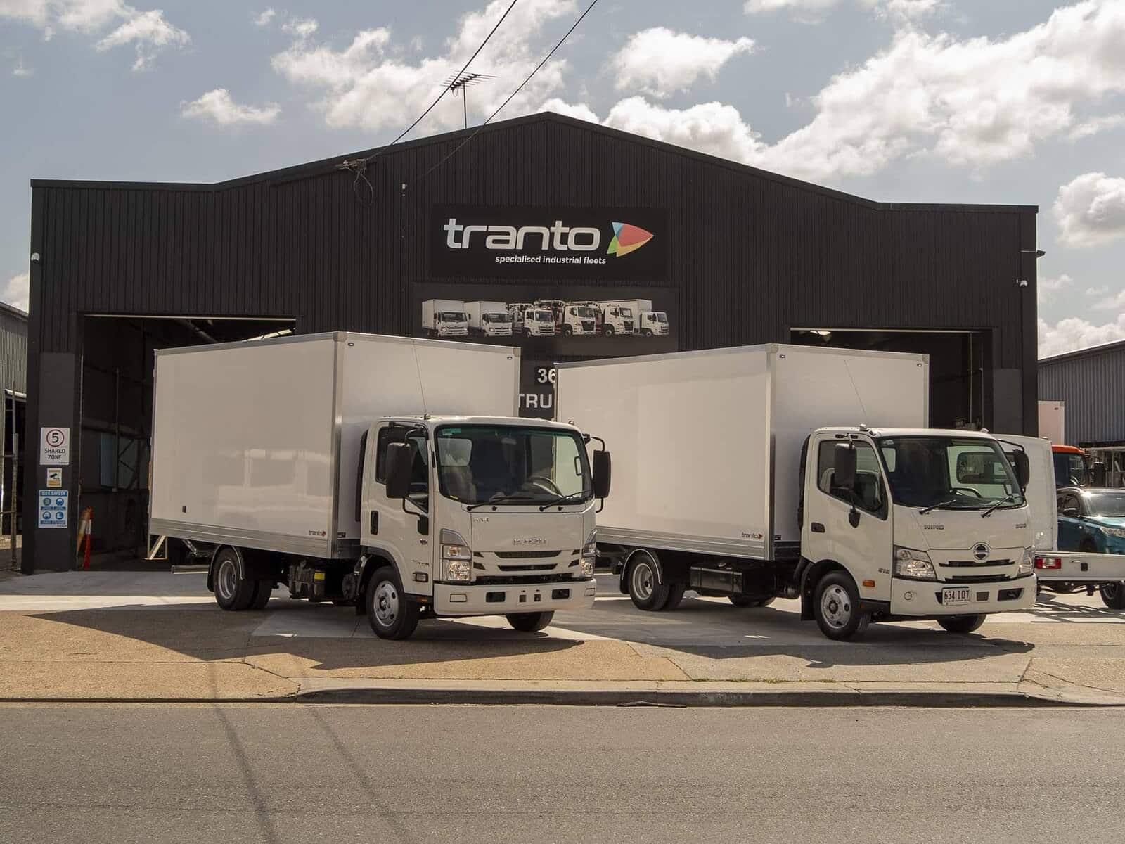 Two Tranto pantechs on Isuzu chassis outside the Tranto shed at Coopers Plains