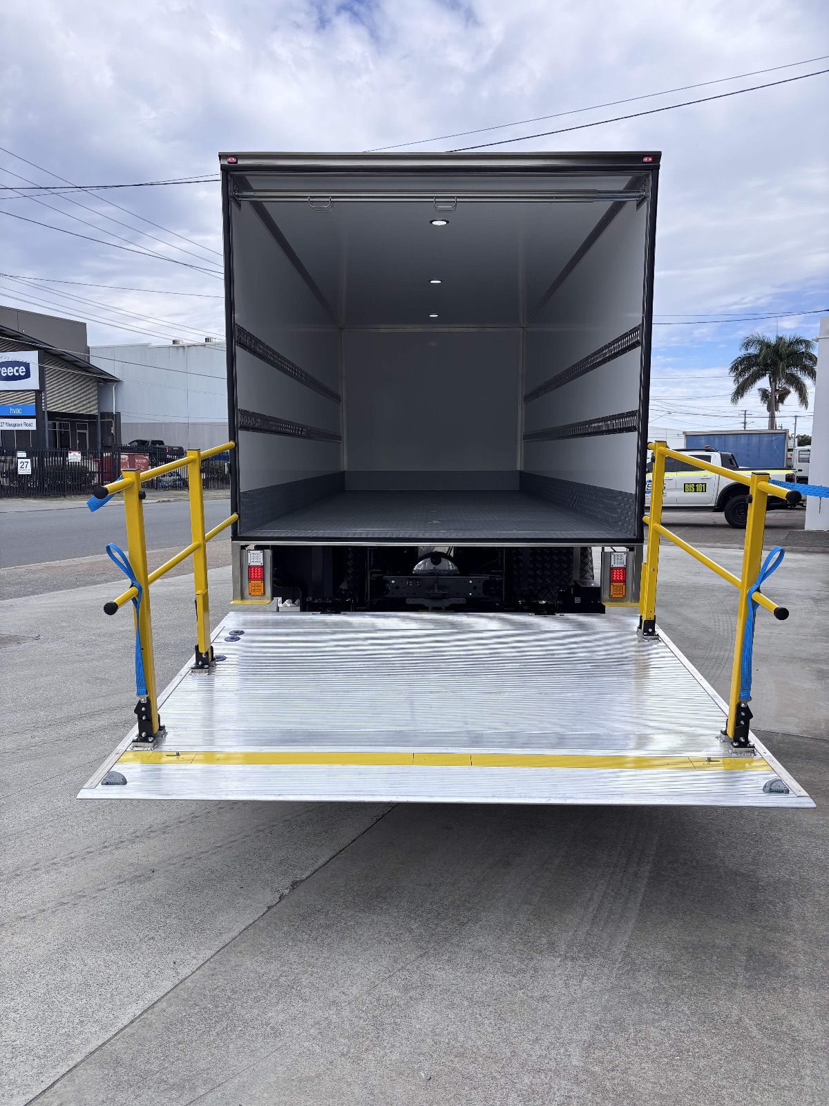 Anteo loader platform with safety rails raised, seen from behind the truck