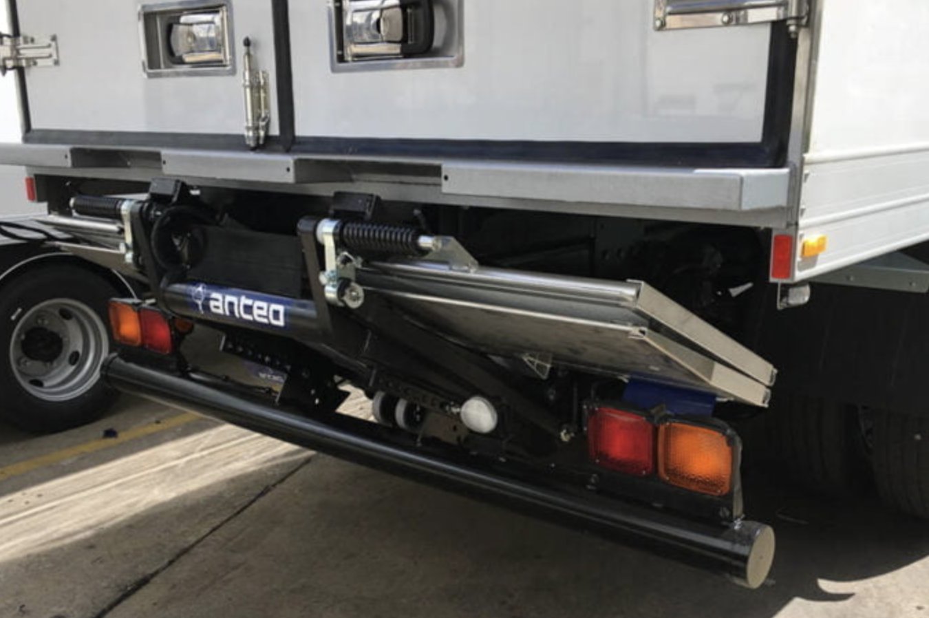 Anteo tuckaway loader folded under the rear of a body